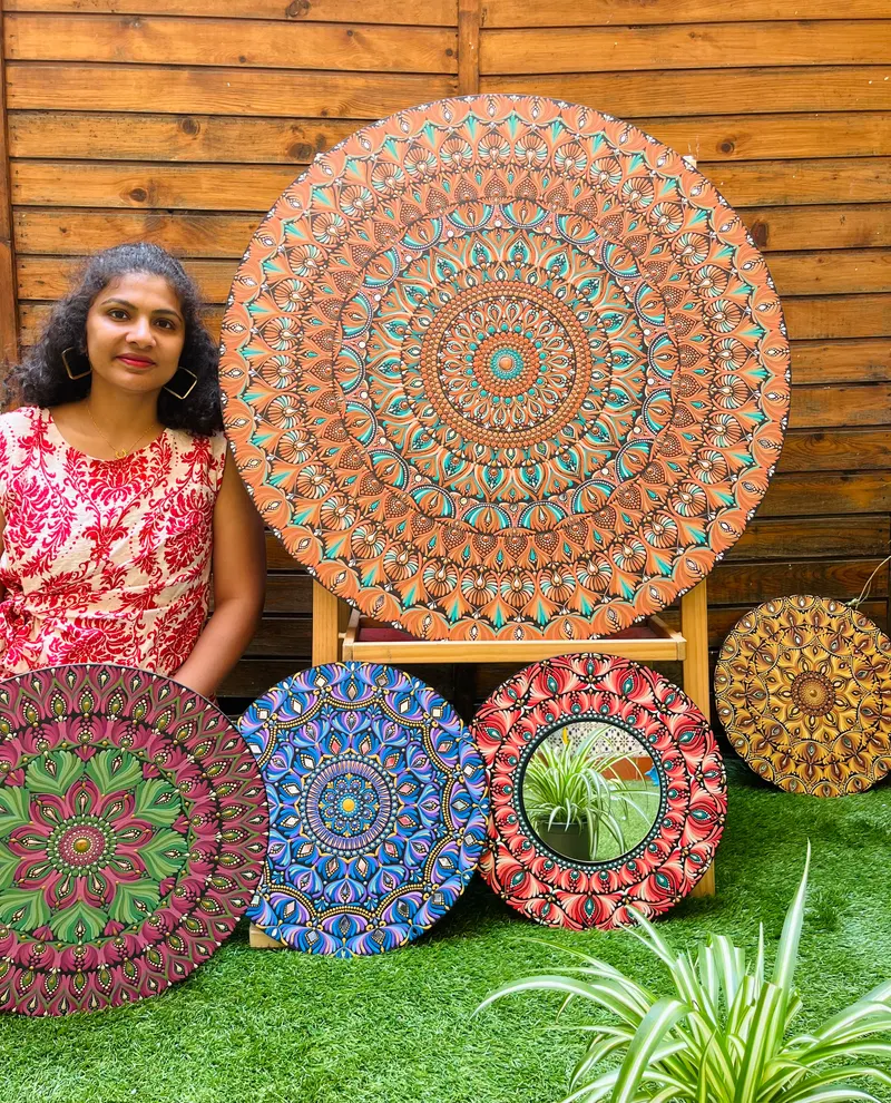 Chaya Jathan painting a dot mandala
