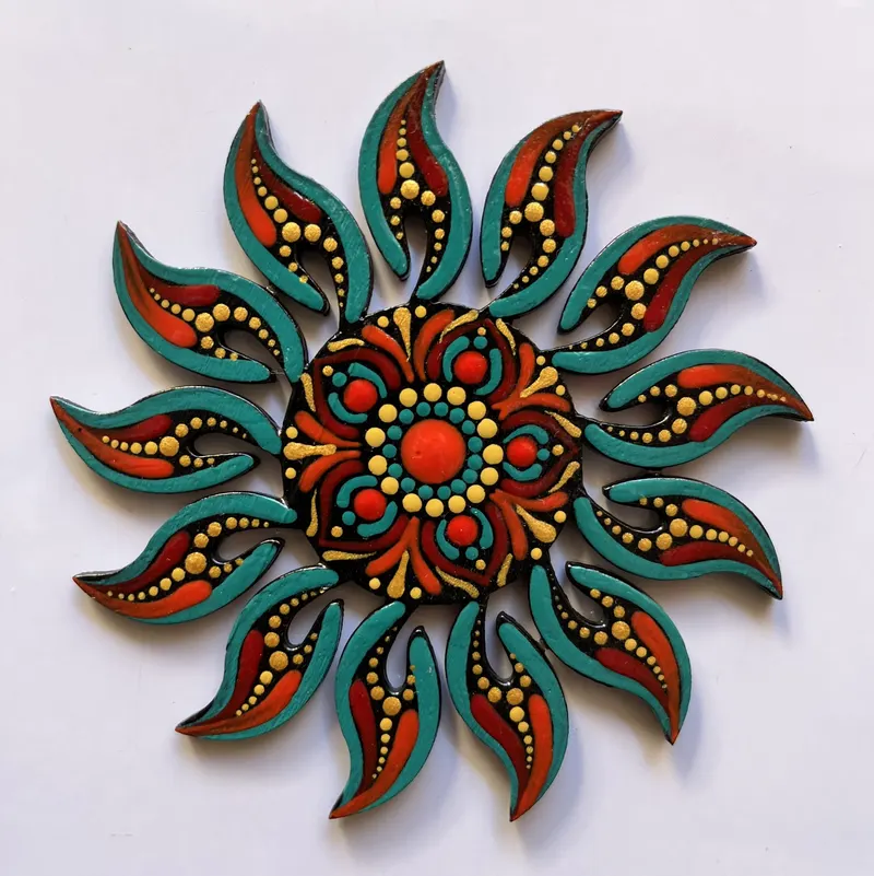 Sun-shaped mandala fridge magnet in red, teal and gold dots